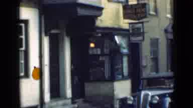 London England (1946): View Of Small Shop People Walking Towards Large Castle