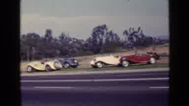 San Diego California USA (1949): Old Red And Blue Cars Race Against Each Other
