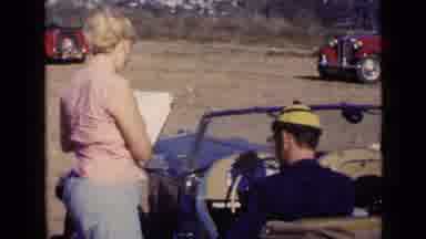 San Diego California USA (1949): Woman And Vintage Car Driver Checking Paperwork