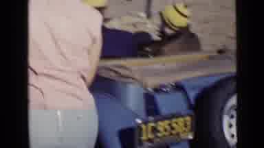 San Diego California USA (1949): Woman Viewing The Rear Of A Car In A Dirt Race