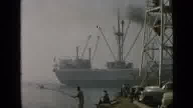 San Diego California USA (1949): Big Ship Sailing Across While People Fishing At