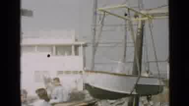 San Diego California USA (1949): A Boat Is Lifted Into The Water While People