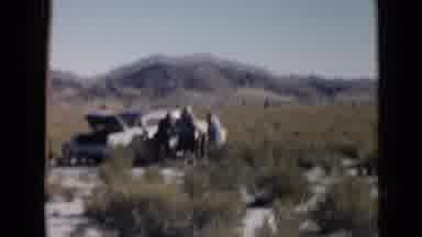 San Diego California USA (1949): Four People Standing By An Old Car In The Desert