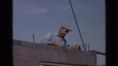 San Diego California USA (1949): Laborer Building A Grey Brick Wall With Cement