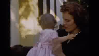 San Diego California USA (1949): Mother Holding Young Child Near House With Two