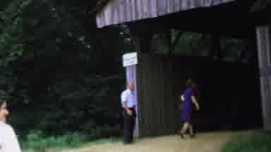 Washington DC USA-1969: Grandma In Blue Dress Walks Into Covered Bridge Entrance