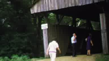 Washington DC USA-1969: A Small Group Of People Walking Around A Wooden Covered Bridge