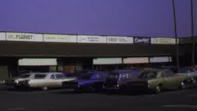 Washington DC USA (1969): Red Vehicle Drives Past Vintage-Style Cars In A Parking