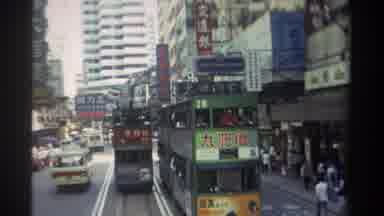 Hong Kong (1982): Busy Narrow Street With Cars Buses And People Passing By During