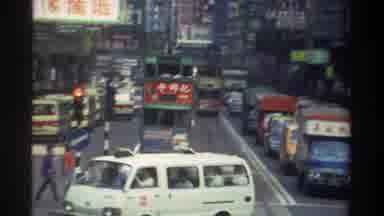 Hong Kong (1982): Trucks Cars And Busses Travelling Down A Busy Congested Asian