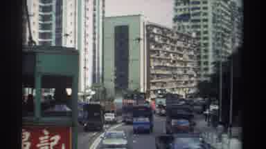 Hong Kong (1982): Busy Street In Asia With Cars Trucks And Trams Driving By And A
