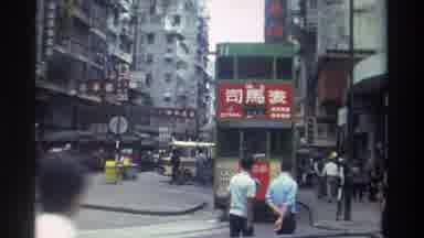 Hong Kong (1982): Passing Green Electric Double Decker Buses On City Streets