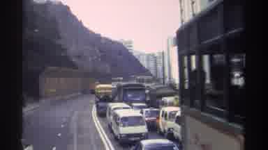 HONG KONG-1982: Electric Street Car And Traffic Jam On A Cloudy Day