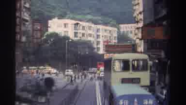 Hong Kong (1982): A Busy Road In A Bustling City Surrounded By Mountainous Tree