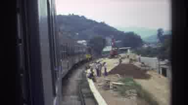 Hong Kong (1982): Train Passing Workers On A Jobsite