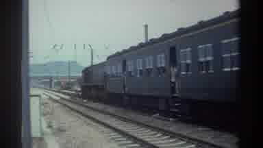 Taiwan (1982): People Looking Out Of Moving Train Cars On A Cloudy Day