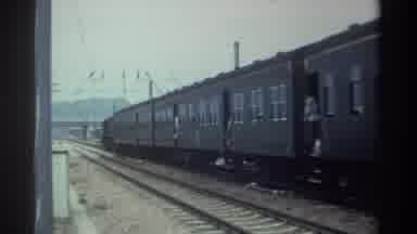 Taiwan (1982): An Old Fashioned Passenger Train Car Travelling Down A Track At