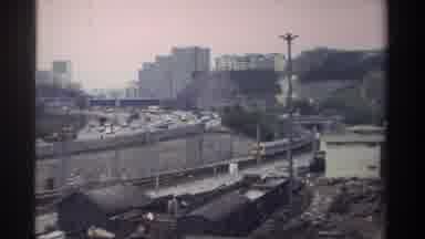 Taiwan (1982): Train Traveling Alongside Of Busy Highway On A Cloudy Day