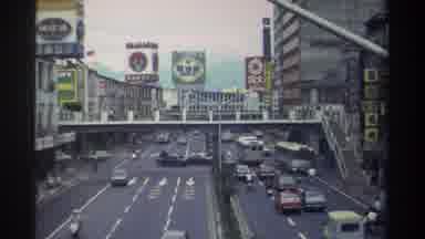 Taiwan (1982): Traffic Passing Under A Large Walking Bridge In The Center Of Town