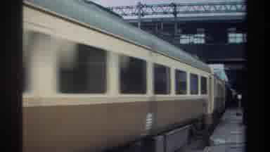 Taiwan (1982): Fast Brown And Tan Train Close Up Under A Large Bridge Speeding By