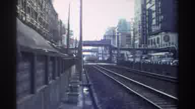 Taiwan (1982): Train Tracks Through Busy City Streets On A Cloudy Day