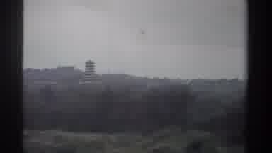 Taiwan (1982): Passing By A Really Tall Tower With Trees Hovering Over The City