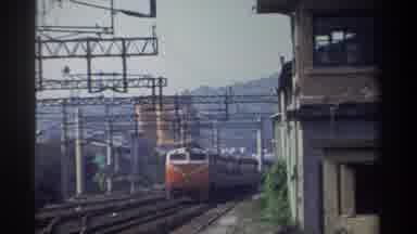 Taiwan (1982): Orange Colored Train Traveling On Tracks Through Train Yard On A
