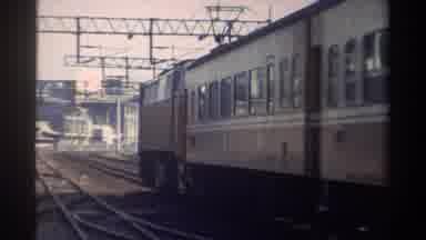 Taiwan (1982): Electric Rail Cars On An Above Ground Outdoor Track Moving Into The