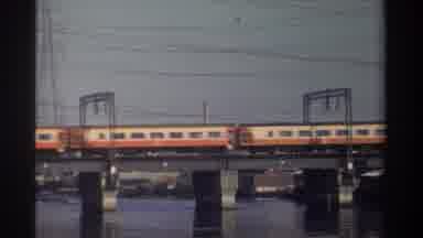 Taiwan (1982): Many Cars Of A Passenger Train Crossing Over A Bridge With Water
