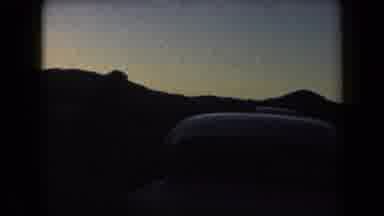 Arizona USA (1958): People Mill About Parked Cars In Front Of Hills At Sunset