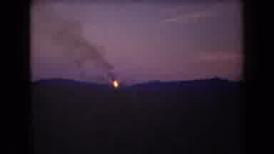 Arizona USA (1958): Mountains At Night Fire In The Distance With Smoke Rising Up