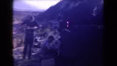 Arizona USA (1958): Man Eating While Others Are Inspecting The Area