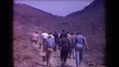 Arizona USA (1958): Group Of Hikers Walking Up A Dirt Path In Mountainous Terrain