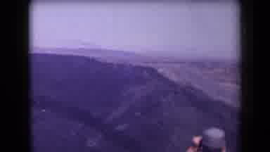 Arizona USA (1958): Man Uses Binoculars To Look Into A Canyon Next To A Highway