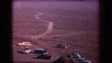 Arizona USA (1958): Cars In The Desert Near A Path With Mountains In The Distance