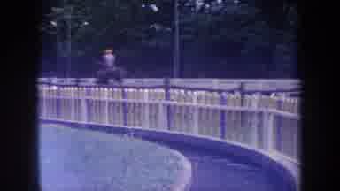 Michigan USA-1968: People Ride Horses On A Fenced Track Followed By Cars Parked