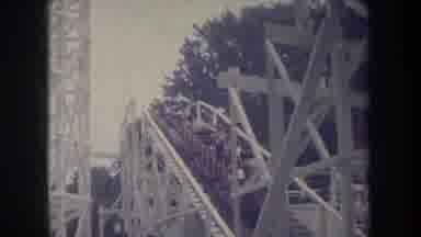 Michigan USA (1968): Amusement Park Roller Coaster White Track Uphill People Green