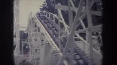 Michigan USA (1968): Red Flowers And Roller Coaster On A Clear Day