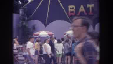 Michigan USA (1968): People Enjoying Amusement Park Ride And Standing In Line To