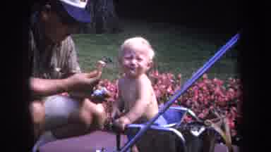 Michigan USA (1968): Cute Child Is Sharing Happy Moments With Its Father In The