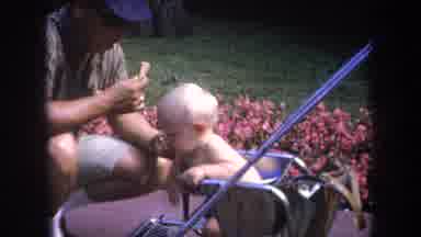 Michigan USA (1968): Man Feeding Baby And Train Ride