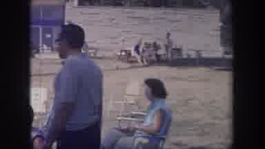 Michigan USA (1968): People In Lawn Chairs Eat On The Lawn Of A Building In The