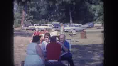 Michigan USA (1968): People Eating At Outdoor Picnic Table Black White Dog Running