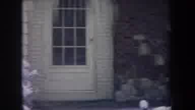 Michigan USA (1968): House With Snow Falling In Yard And Icicles On Trees