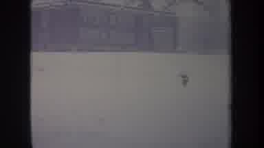Michigan USA (1968): Snowy Building And Grounds With Dog Running Past