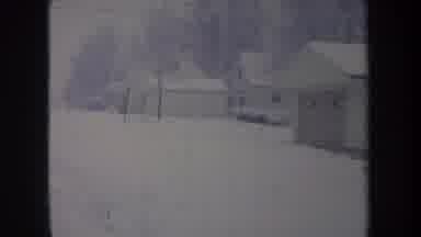 Michigan USA (1968): Snowy Old Style Pan Clip Of Garage And Pine Tree Covered In