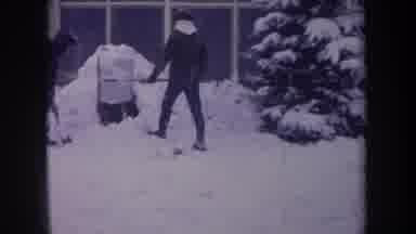 Michigan USA (1968): Kids Shovel Snow Into A Hole That They Have Built