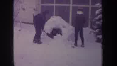 Michigan USA (1968): Two Young Boys Outside Shoveling A Pile Of Snow With Shovels