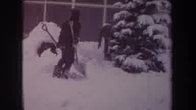 Michigan USA (1968): Two Young Boys Playing In A Snowstorm With Shovels And Snow