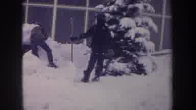 Michigan USA (1968): Small Young Children Shoveling Snow To Make A Snowman